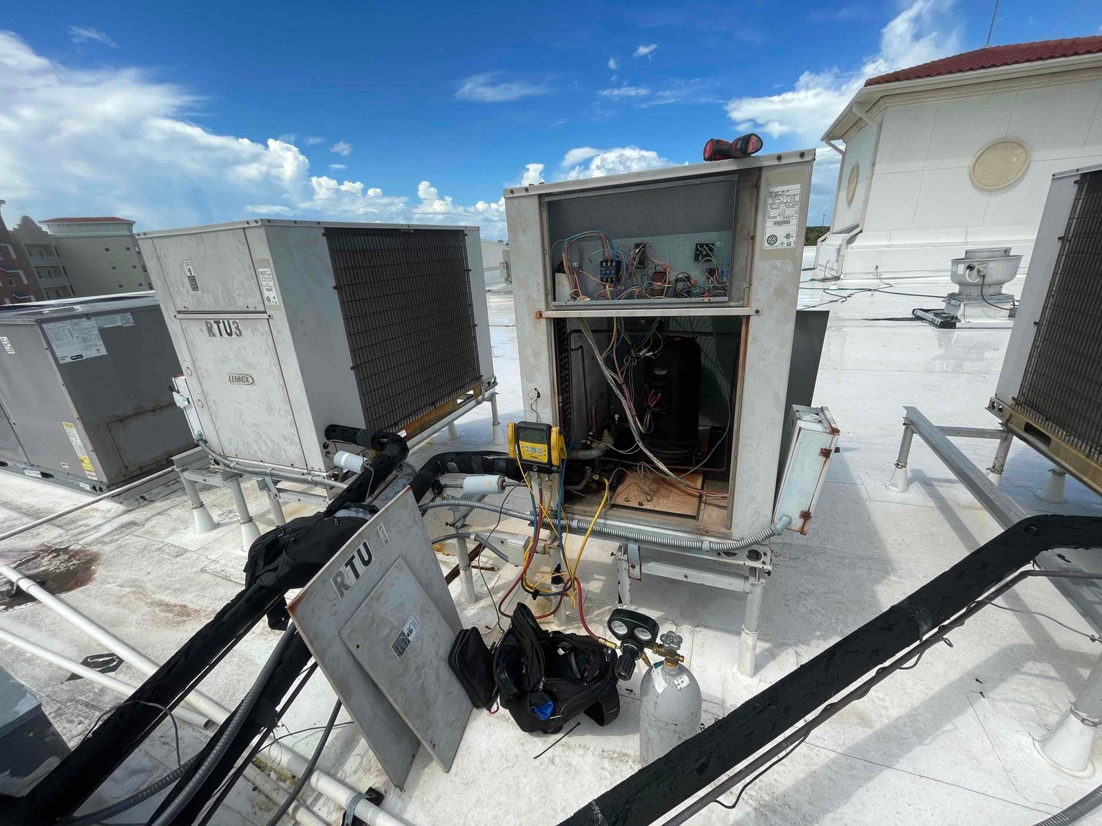 Commercial rooftop HVAC system being serviced